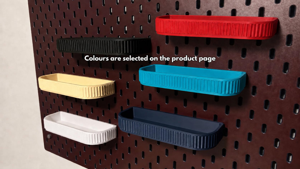 Six fluted storage trays in different colours on a SKÅDIS pegboard. Colours are selected on the product page.