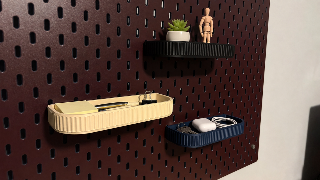 Cream, navy and black trays on a burgundy pegboard